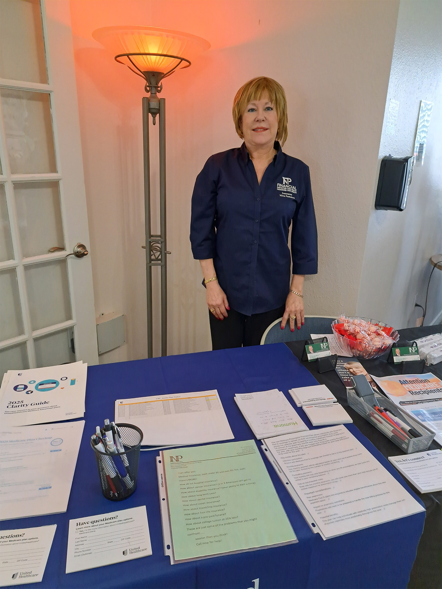 Woman standing in front of a table full of documents